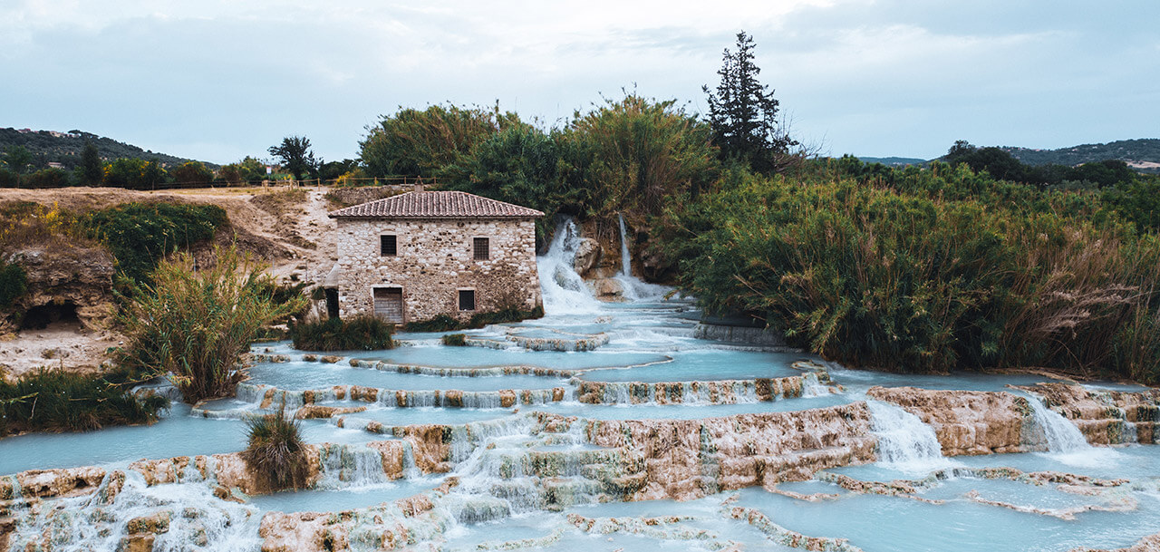 The hot spring of Saturnia located in Tuscany. It needs a car to be reached