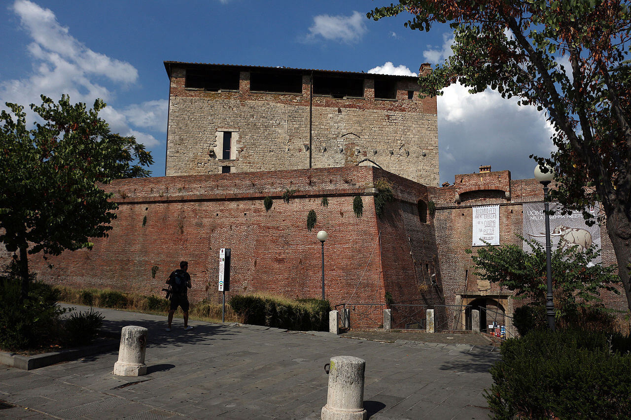 a tourist is photographing the walls of Grosseto, in Maremma