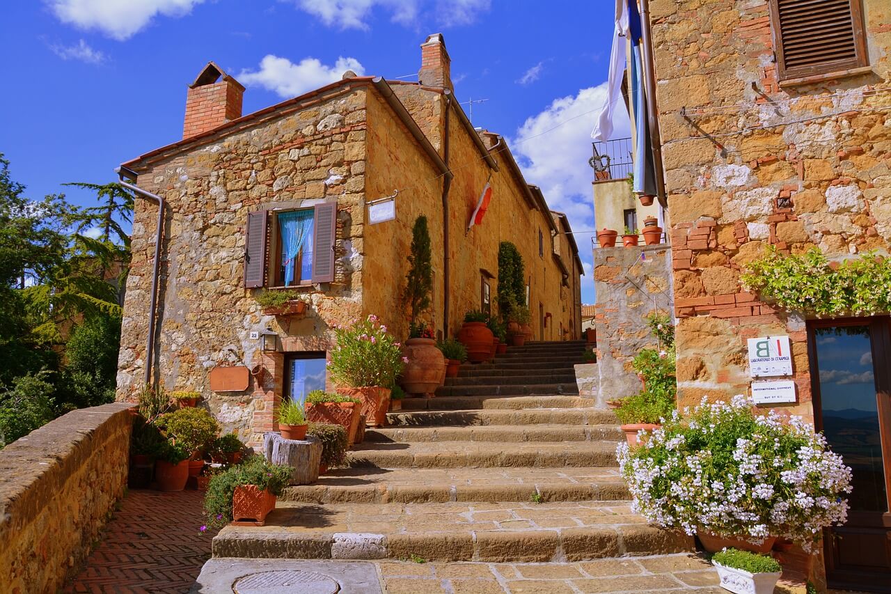 A sunny and colorful alley in Pienza