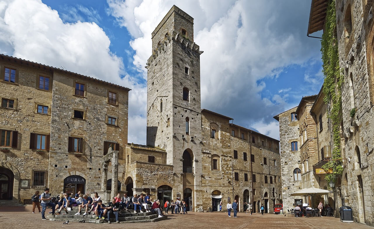 Tourists visiting the historical center of San Gimignano on a day trip from Florence