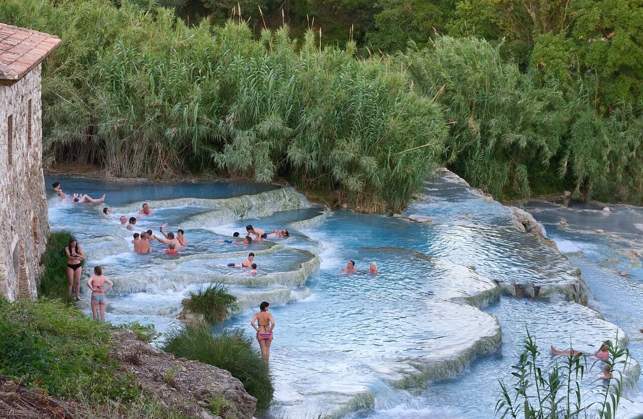 Many tourists enjoy the natural hot spring of Saturnia.