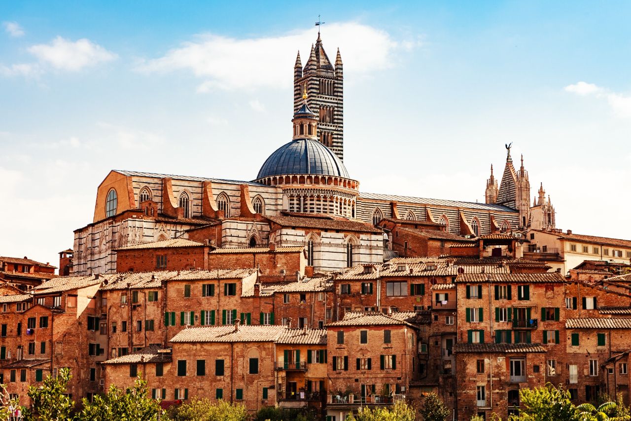The view of the cathedral of Siena, with the typical houses of the whole Tuscan territory