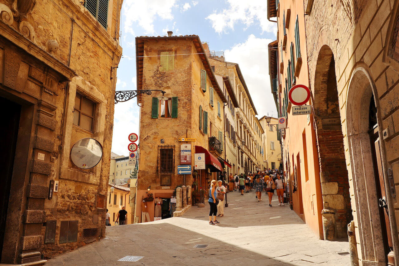 Some tourists are visiting the main street of Montepulciano