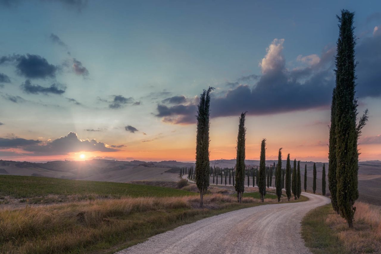 A tourist has rented a car to enjoy the views of the Tuscan countryside and move independently