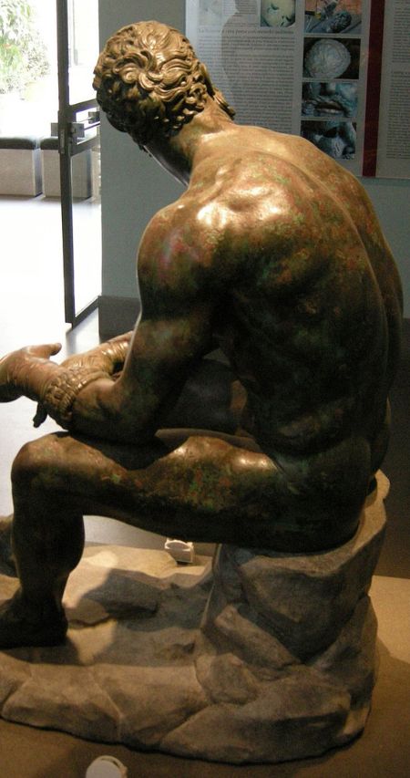 The back of the statue of a boxer at rest in Rome