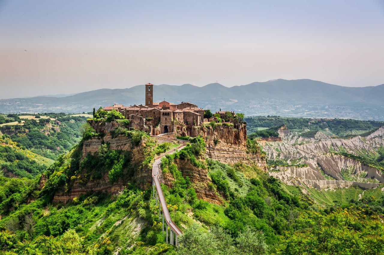 The beautiful place of Civita di Bagnoregio, that surrounded by green trees and grass, near Rome, Italy