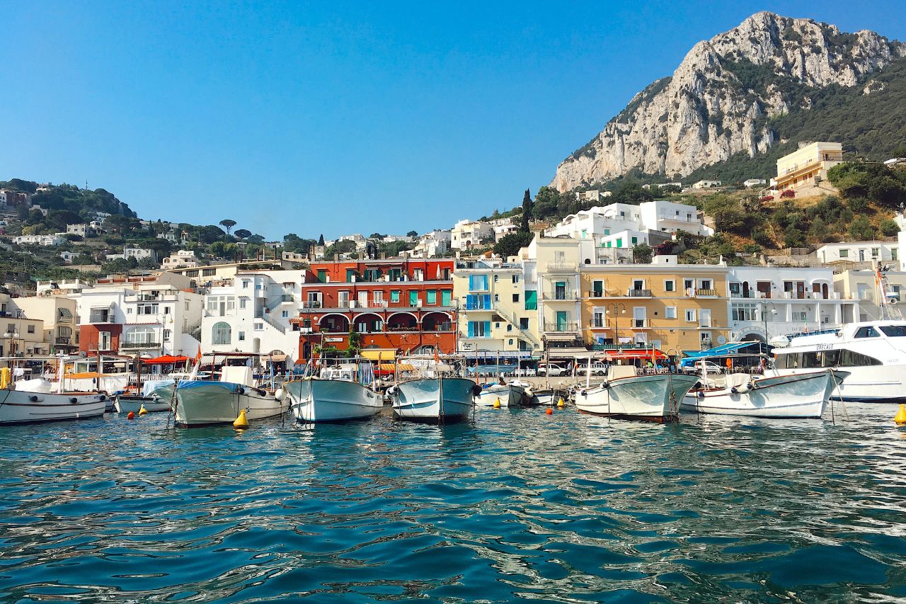 A view of rock mountain and houses from the boat on the beautiful island of Capri
