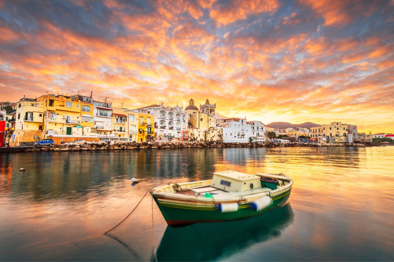 Beautiful clouds and sunset over the houses on Ischia Island.