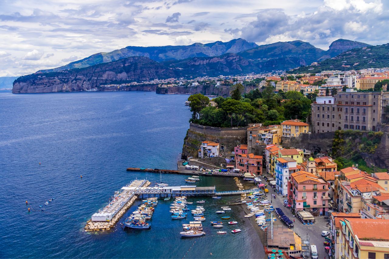 A beautiful town of Sorrento with boats and colorful houses near the sea.