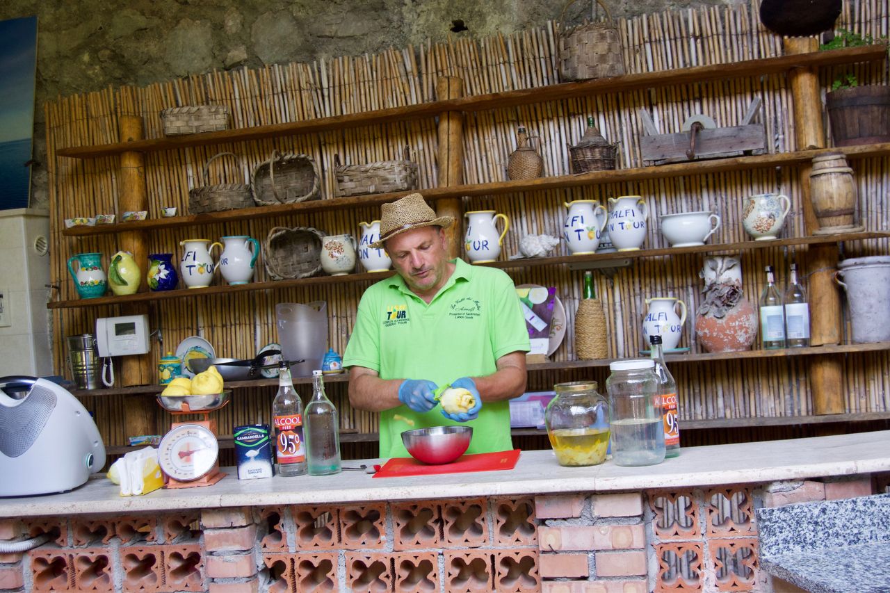 A merchant is preparing limoncello following traditional recipes
