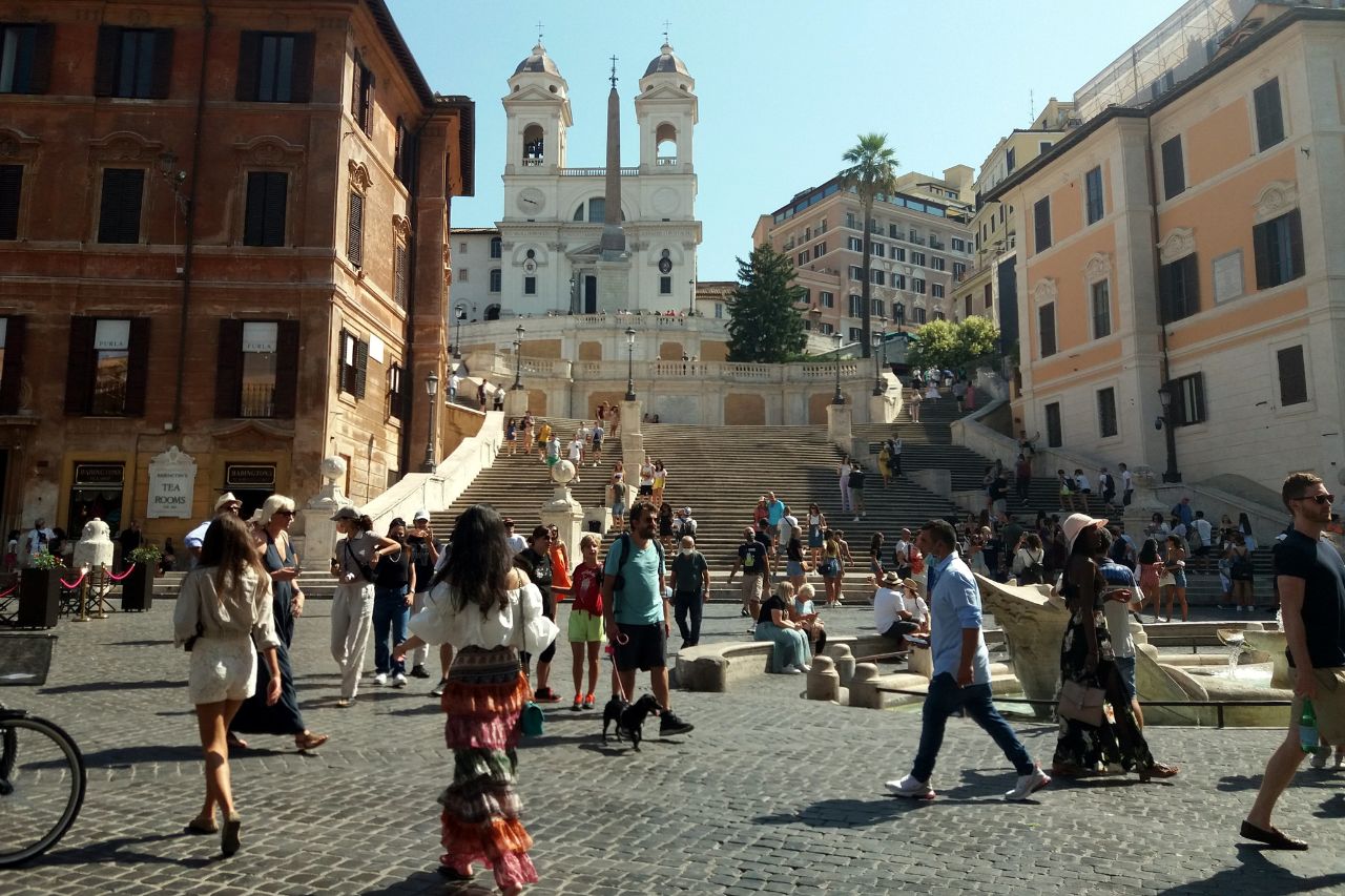 A sunny day it Italy with many tourists enjoying Rome.