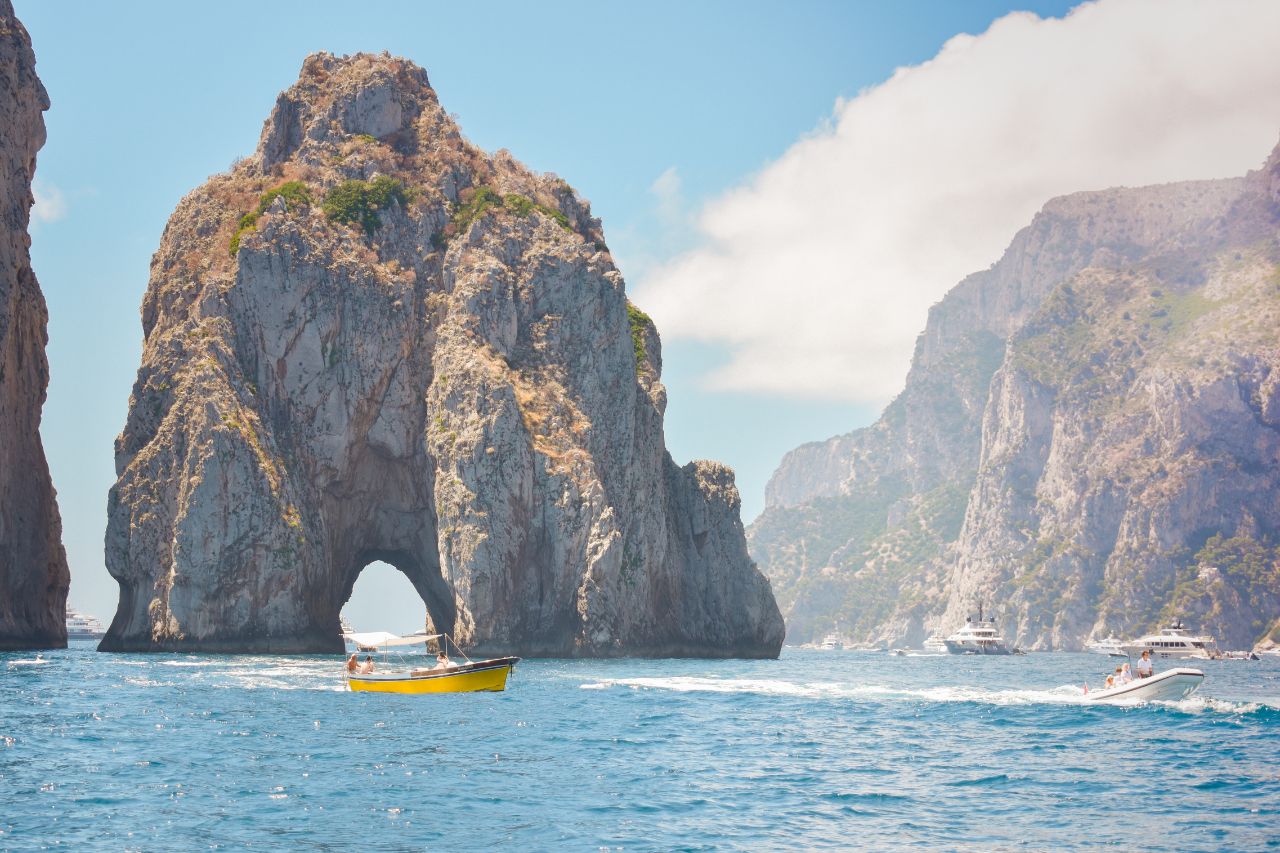 Many tourists enjoy the amazing view of the cliffs of Capri