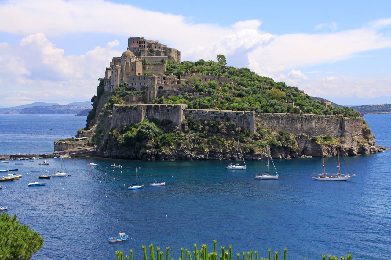 The island of Ischia is located near the Amalfi coast with many tourist boats.