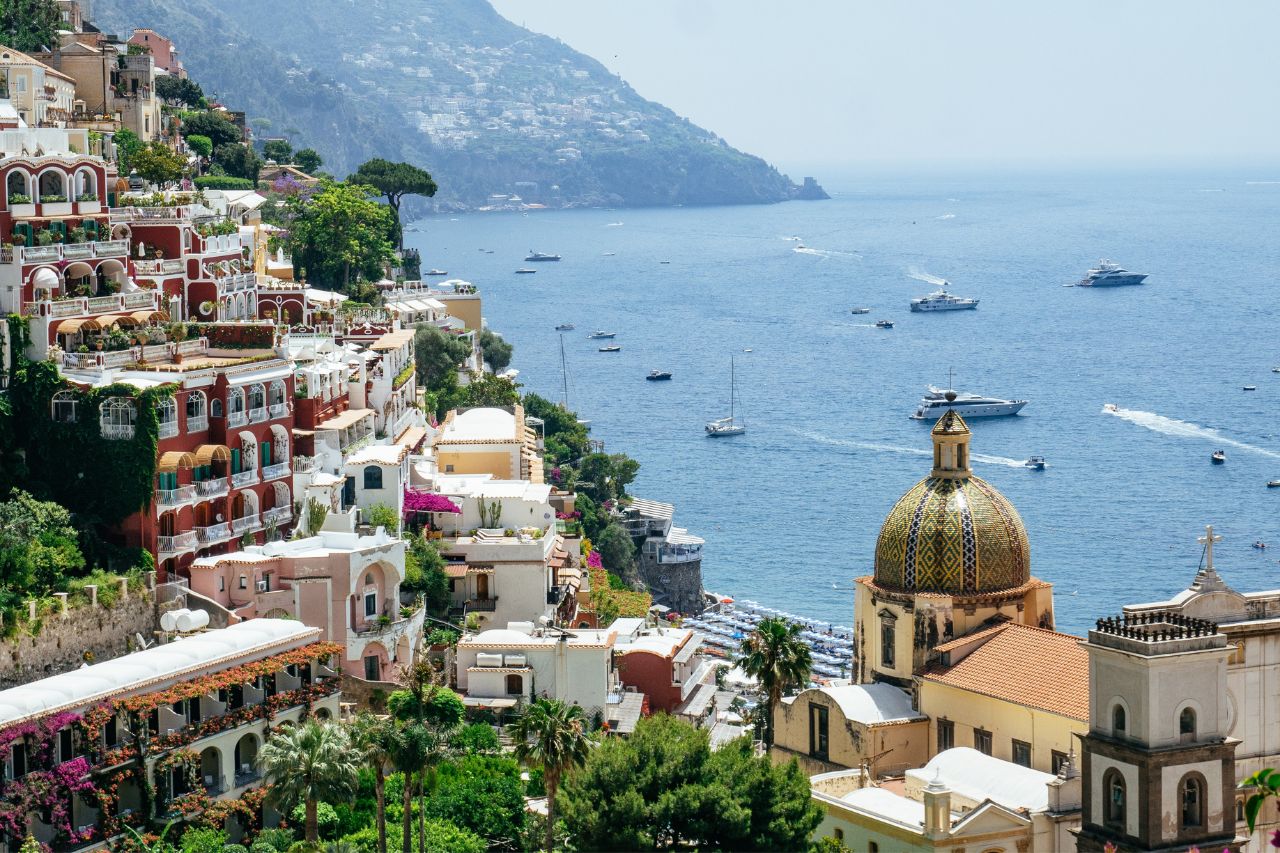 Areal view of the Amalfi Coast with luxury hotels and boats for tourist.