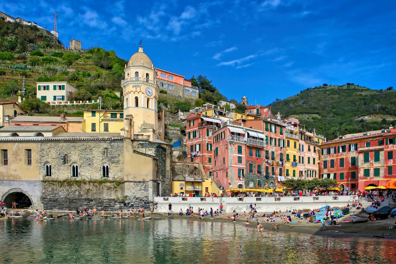 Tourists enjoy bathing on the Amalfi coast beach with sunny weather.