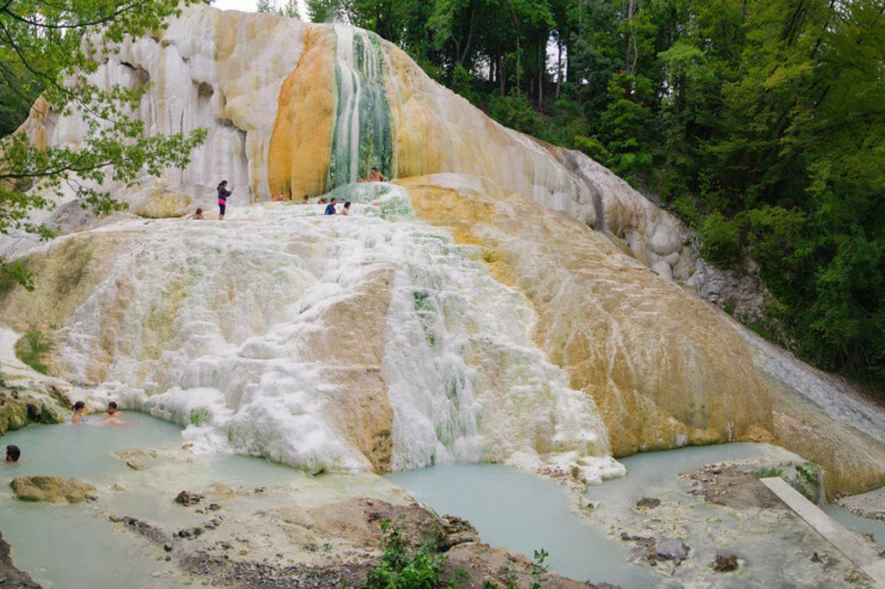 People are relaxing at the Bagni San Filippo hot springs