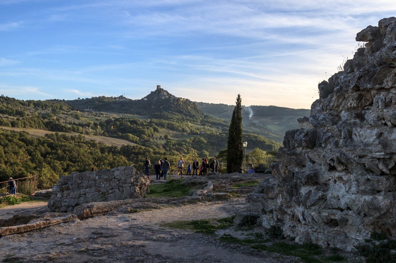 A group of tourists enjoy taking photos on the top of the mountain in Bagno Vignoni.