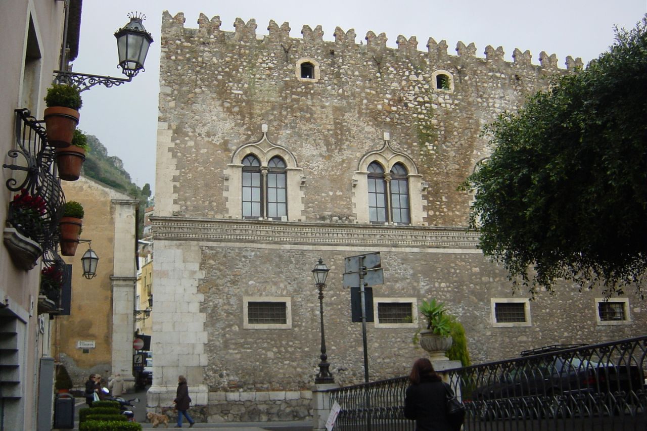 The Palazzo Corvaja is near the street in Taormina, Italy.