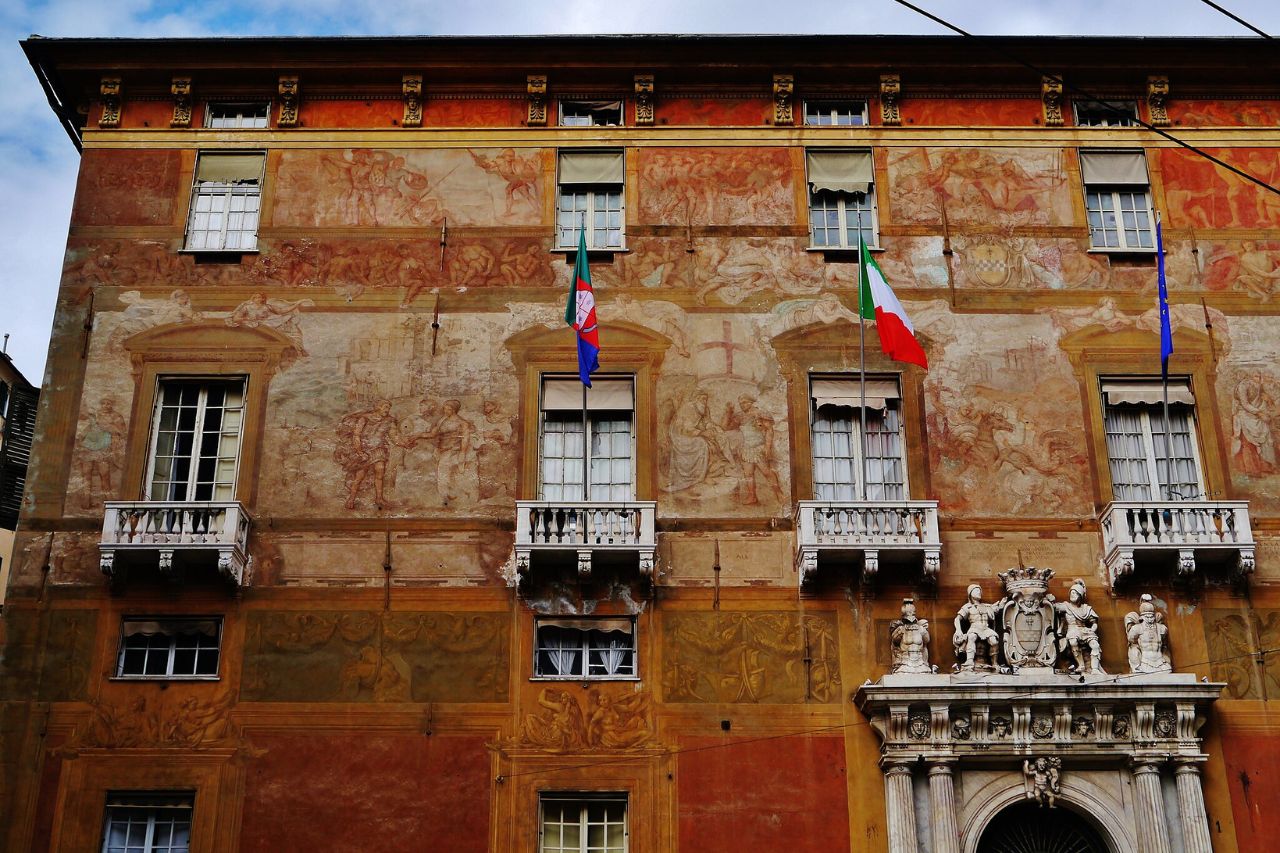 The beautiful Spinola Palace with art portrait on the wall is located in Genoa, Italy. 