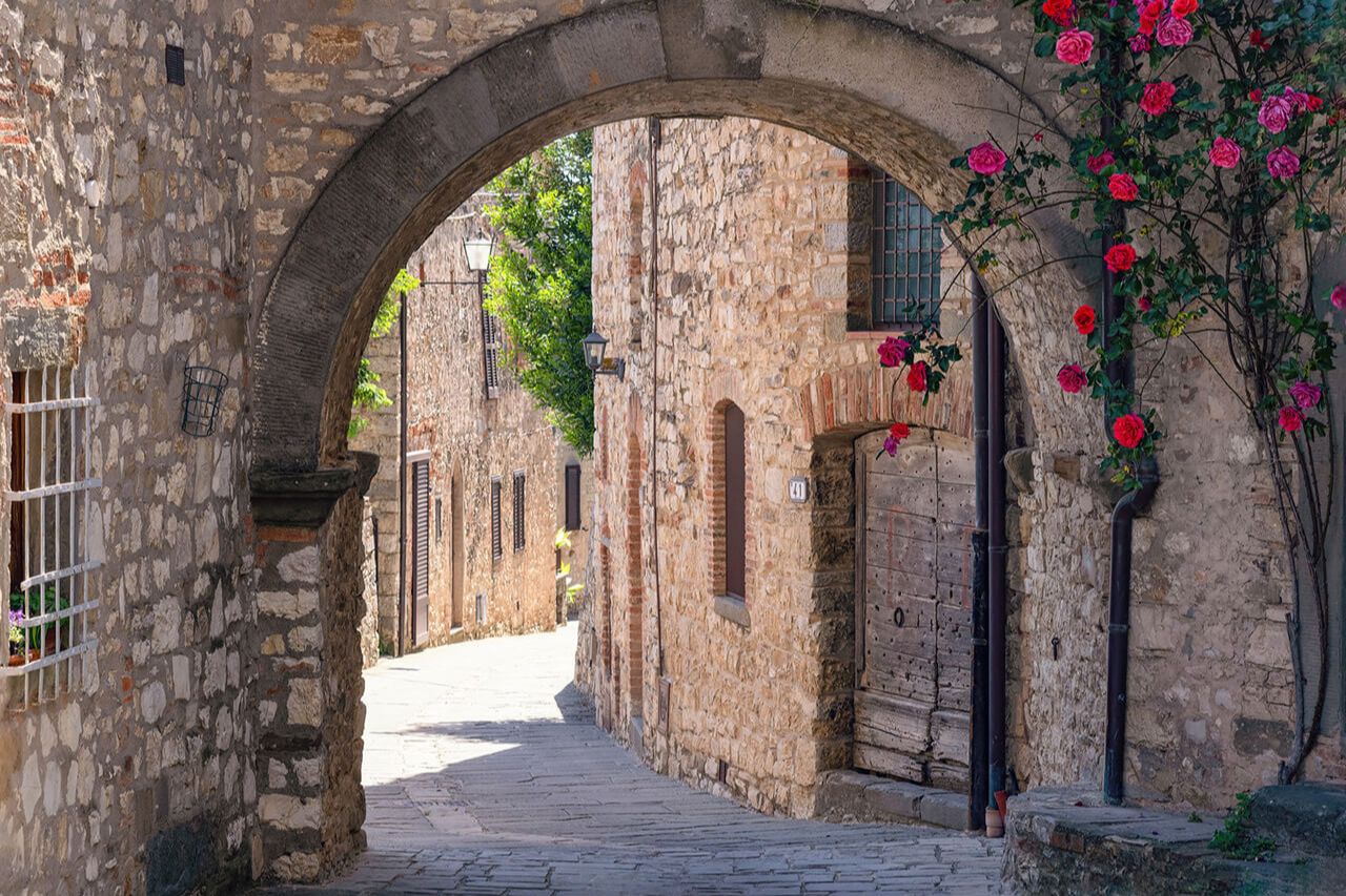 A typical alley of Gagliole in Chianti, with roses embellishing the passage