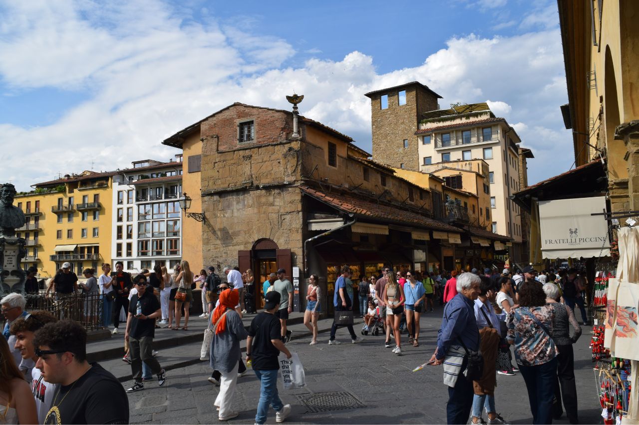 Travelers enjoy shopping in luxury shops in The Ponte Vecchio in Florence.