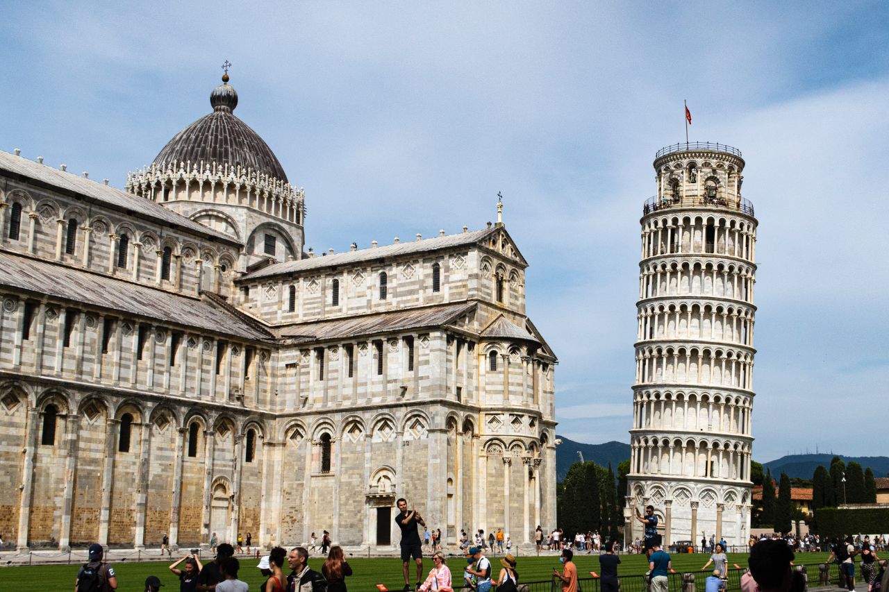 Many tourists enjoy the view of the famous Leaning Tower in Pisa.