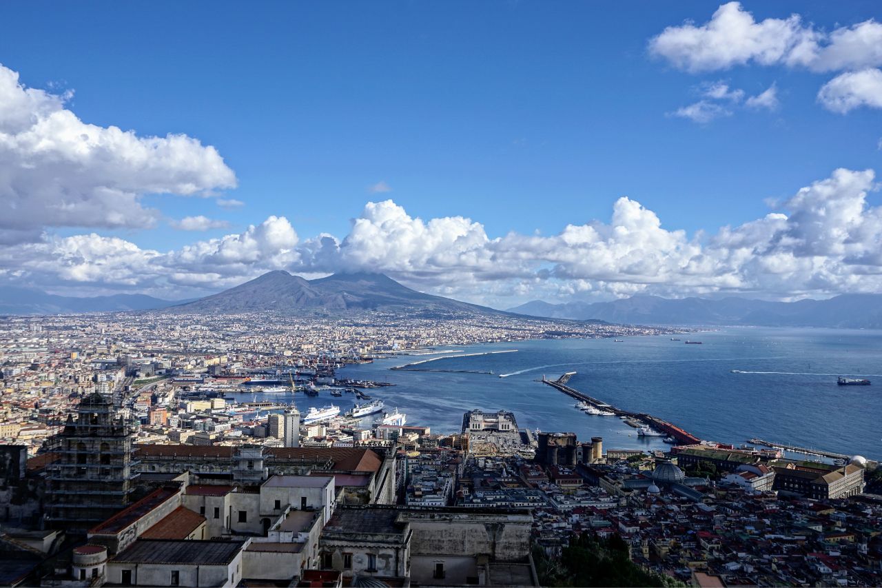 Aerial view of houses and buildings with beautiful sea and mountains in Naples