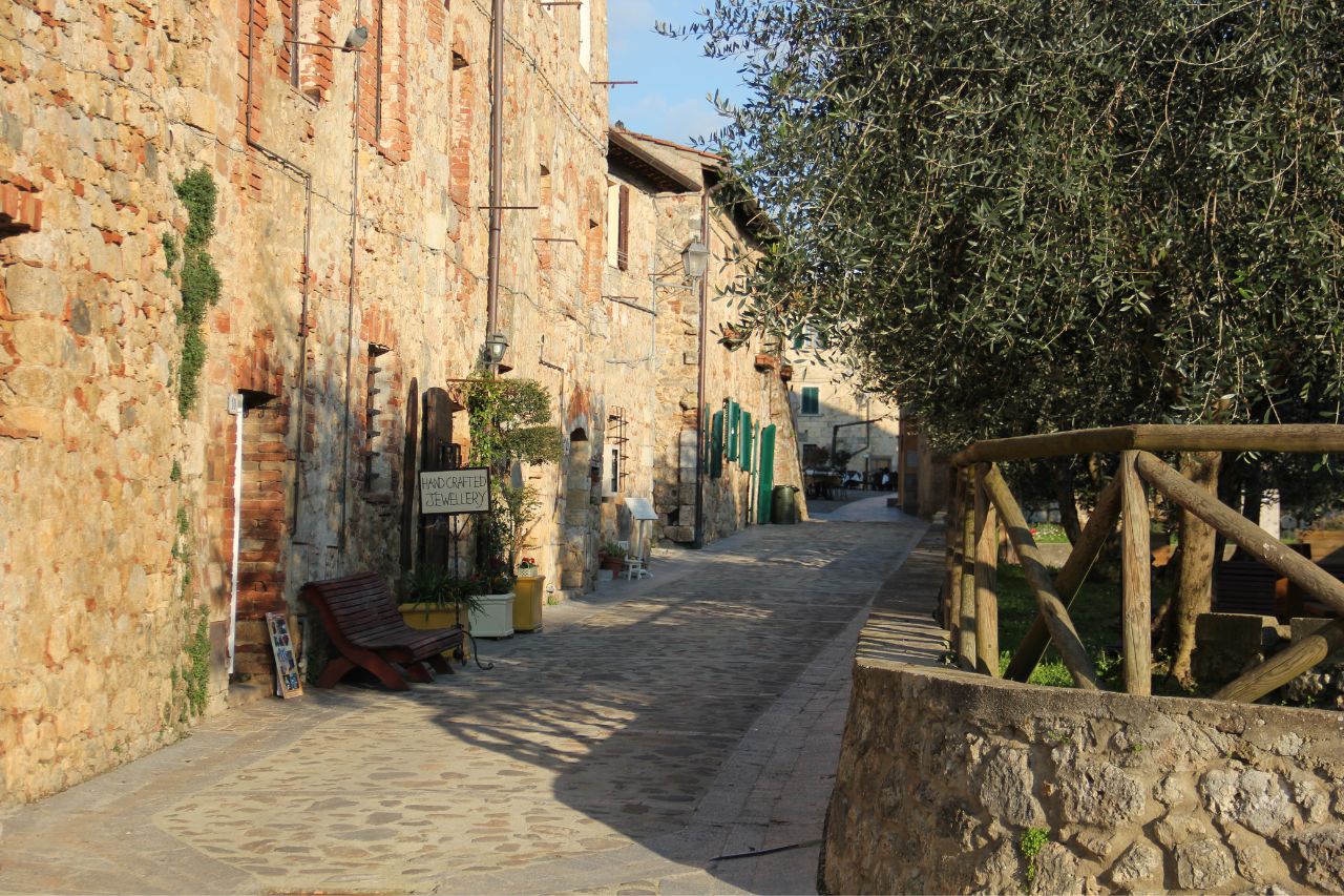 A sunny day on the street in Monteriggioni with ancient houses