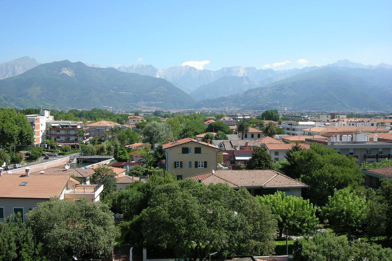 An areal view of beautiful mountains and houses in Tuscan coast.