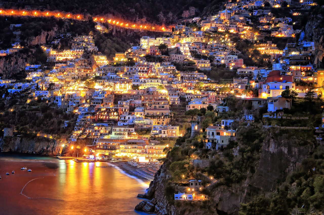 Positano illuminated at night during a summer evening