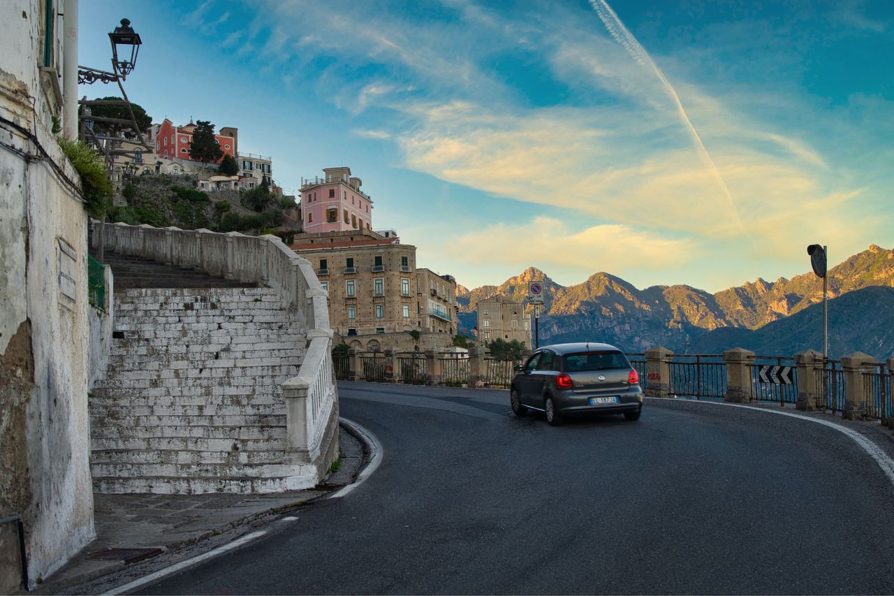 Narrow road surrounded by the best restaurants with beautiful mountain views in Atrani.
