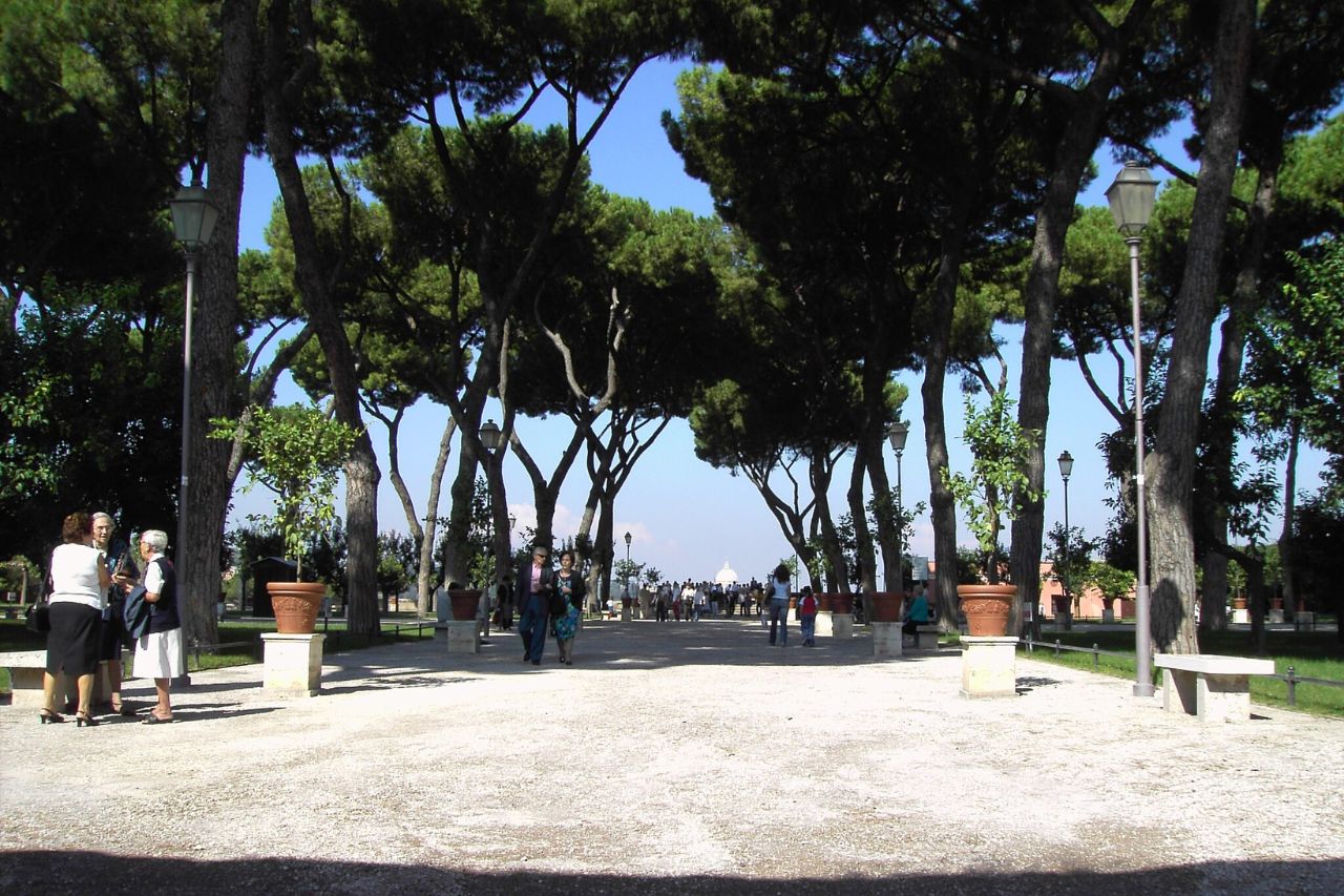 Tourists stroll through the orange garden in Rome