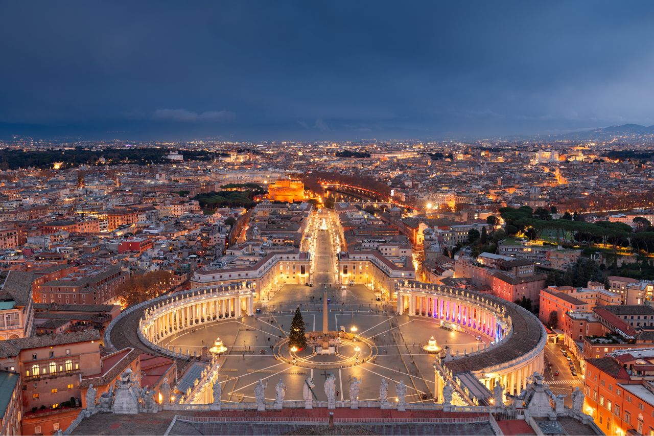 An image of Vatican City and its renowned museums. The picture features the iconic Vatican City walls and possibly the grand St. Peter's Basilica in the background. 