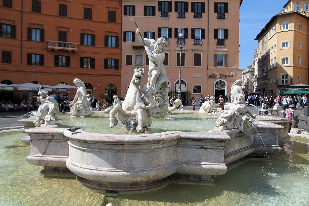 Admire the Fontana del Nettuno (Fountain of Neptune) in Piazza Navona, a magnificent Baroque fountain in Rome. The sculpture features the Roman god Neptune surrounded by aquatic creatures, adding to the charm of this historic square."