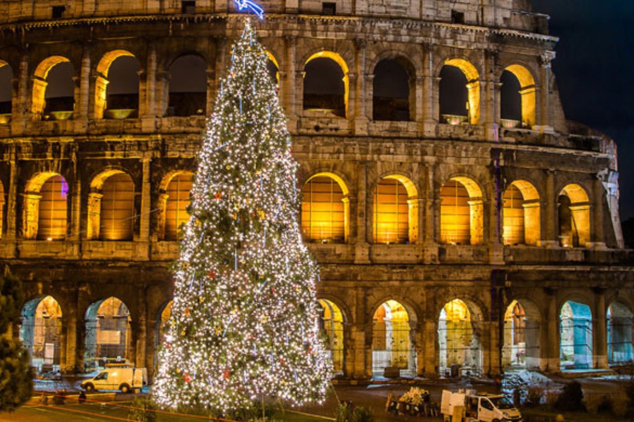 Nighttime view of the Christmas tree near the Colosseum in Rome, Italy. 