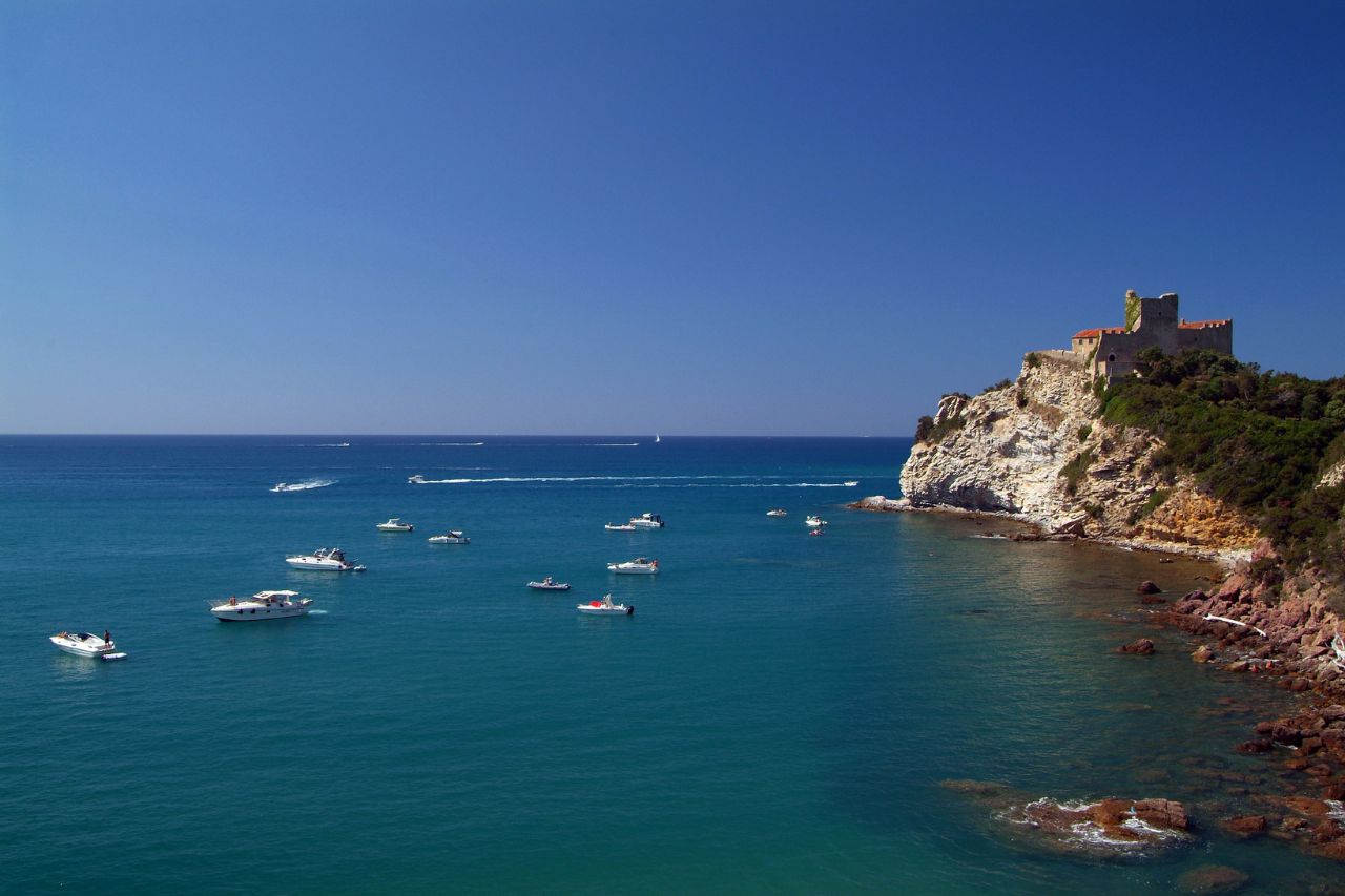 Tourists are exploring Castiglione della Pescaia, on the Tuscany coast, with a boat trip