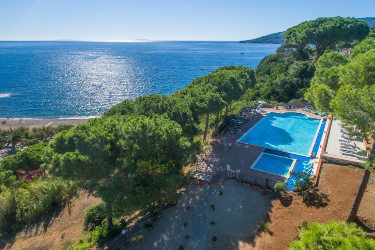 Aerial view of huge swimming pool and gardens near to the beach located at Residence Reale