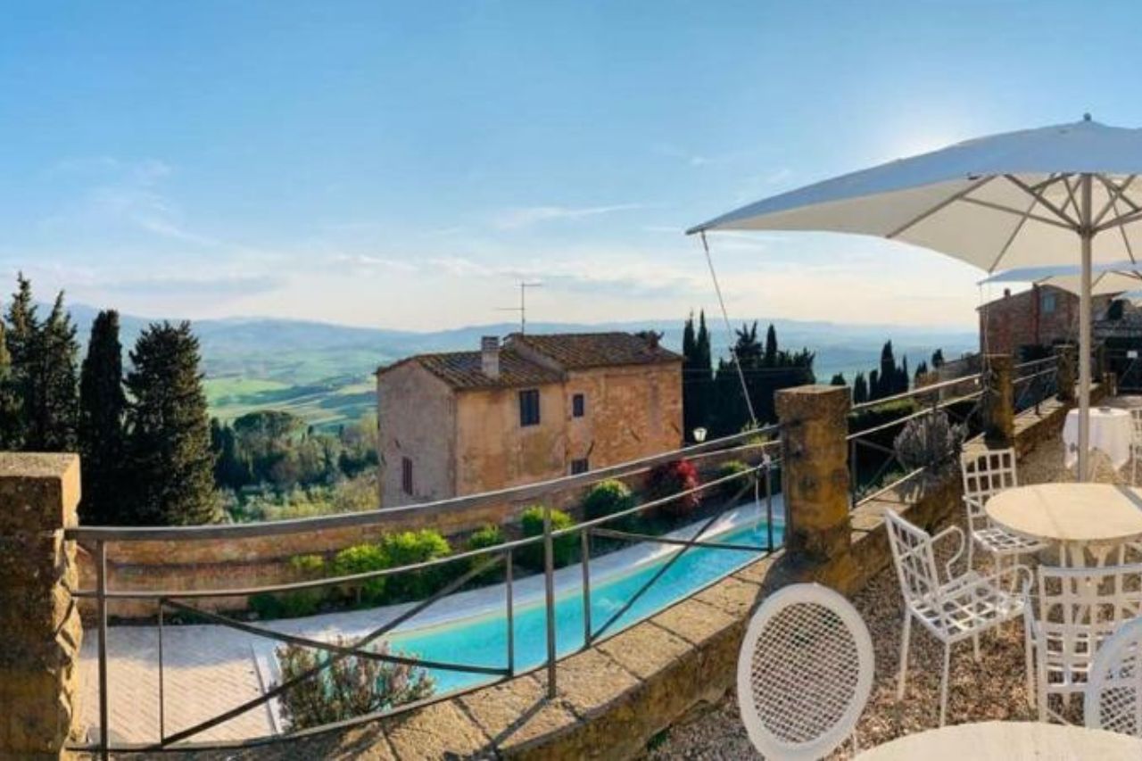 Stunning view of mountain from the terrace with outdoor swimming pool at the Relais Il Chiostro di Pienza 