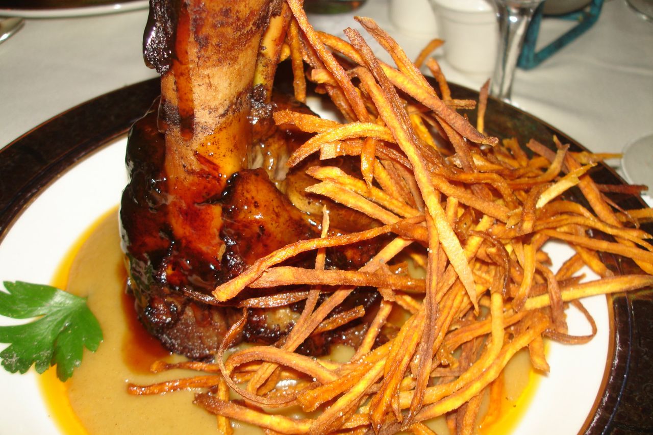 A serving of Osso Buco, an Italian dish featuring braised veal shanks, 