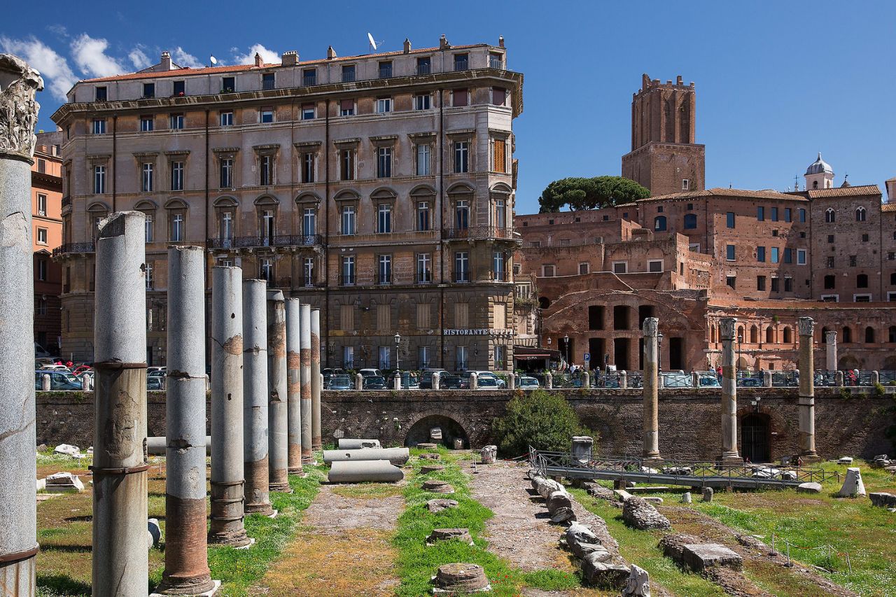 Tourists are walking along the imperial forums in Rome