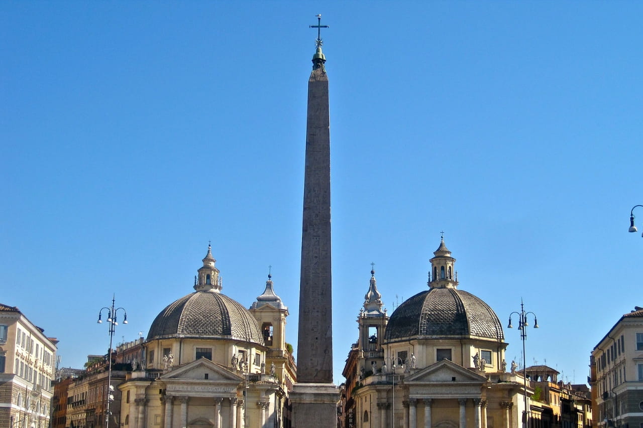 Tourists are observing the beautiful monument of Flaminio - an obelisk