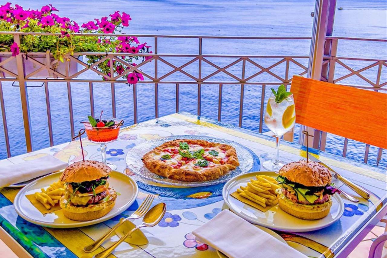 Pizza, Fries, and Pizza are served on the terrace by the Ristorante l’Antica Cartiera.
