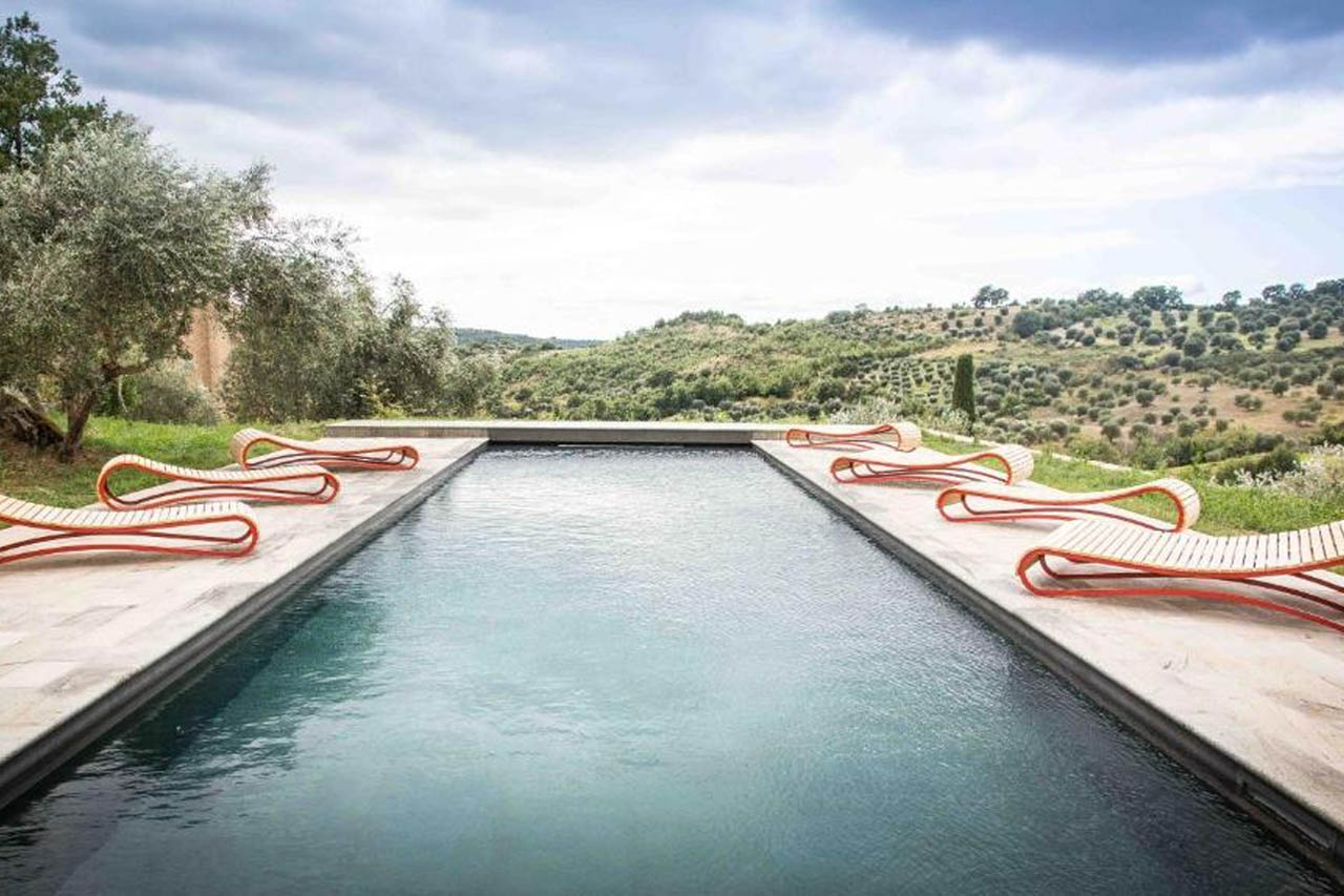 Outdoor pool with a breathtaking view of mountains in Castello Di Potentino