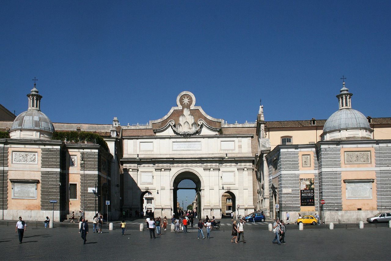 Rome's Porta del Popolo during daylight is crowded with people, near Piazza del Popolo