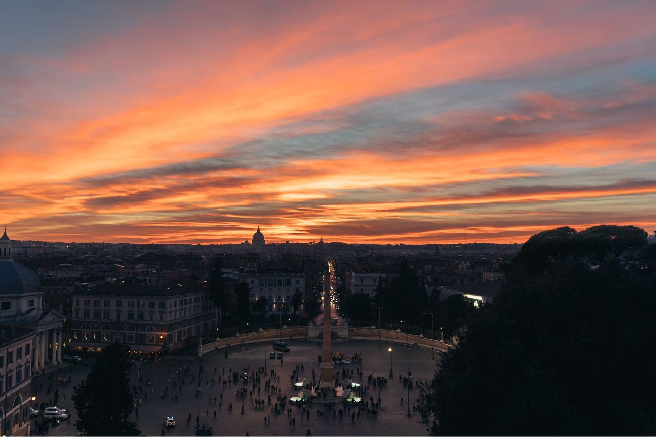 Aerial view of Piazza del Popolo during nighttime with beautiful sunset