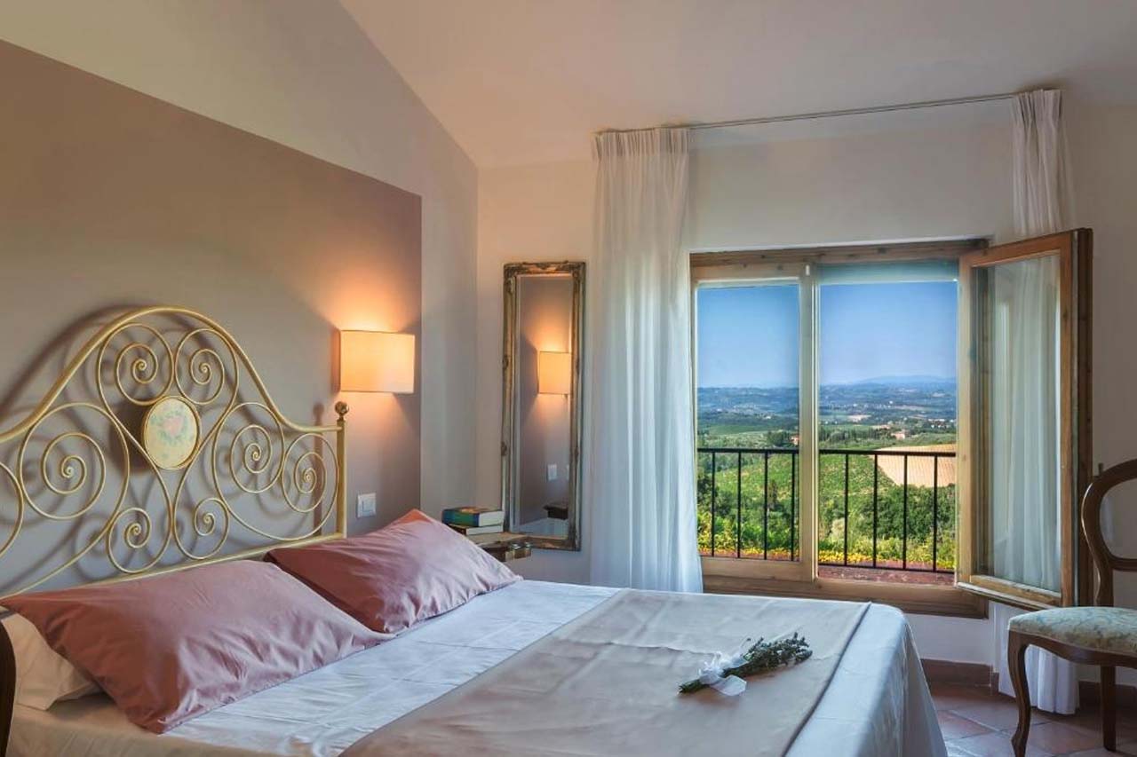 Beautiful room with an overlooking view of the landscape from the window in Hotel San Michele