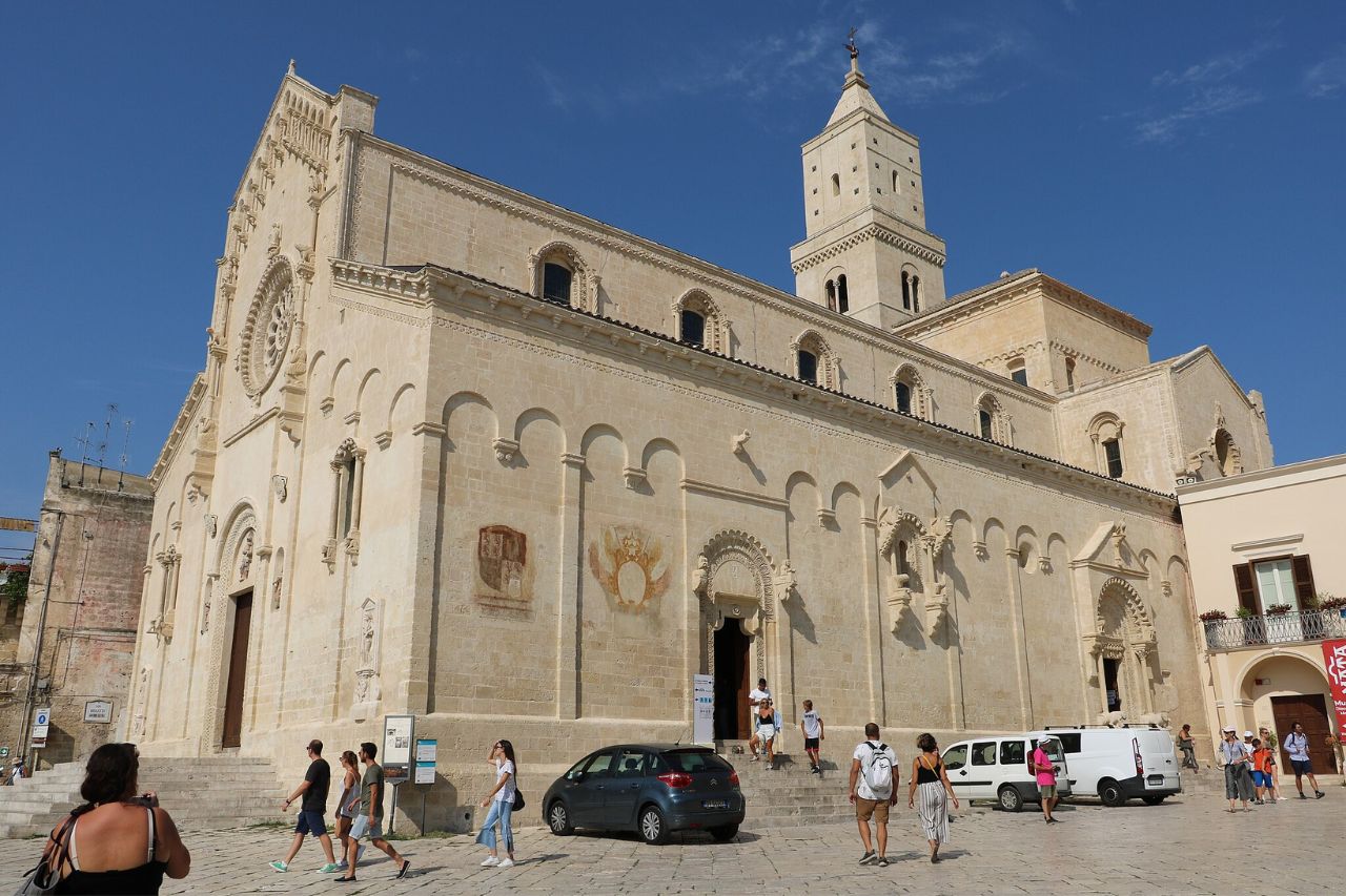 Tourist are enjoying the view of the Cattedrale di Maria Santissima della Bruna e Sant'Eustachio in Italy