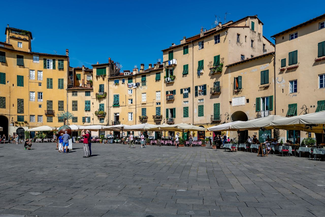 Tourists stroll in the main square of Lucca