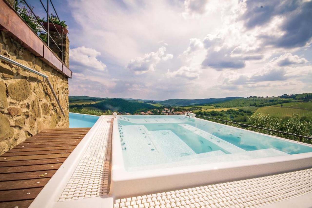Luxury outdoor pool with a stunning view of the landscape in Capannelle Wine Resort