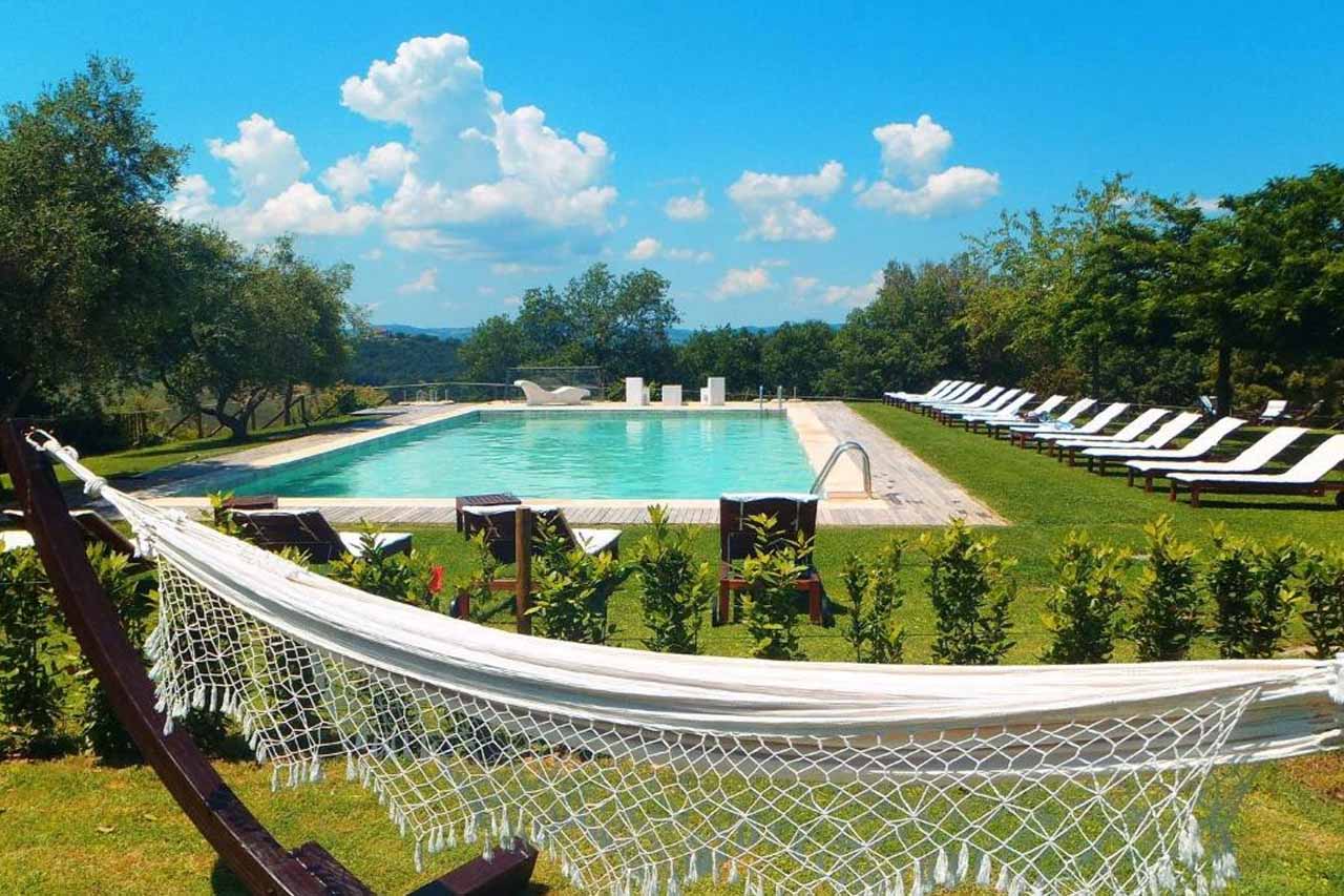 Outdoor pool with stunning view of nature in Relais CastelBigozzi